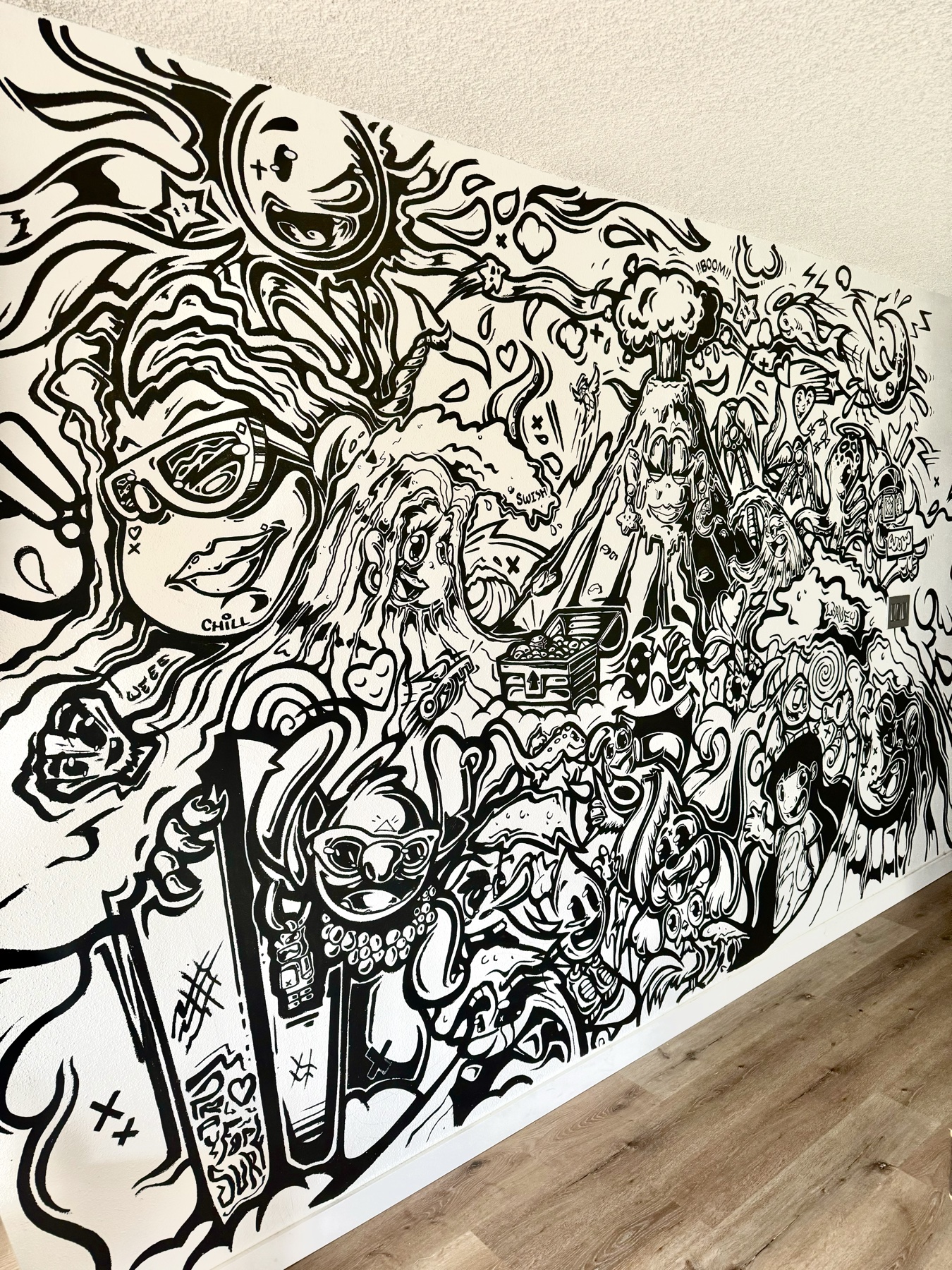Black and white doodle mural painted by Jimi Grins
