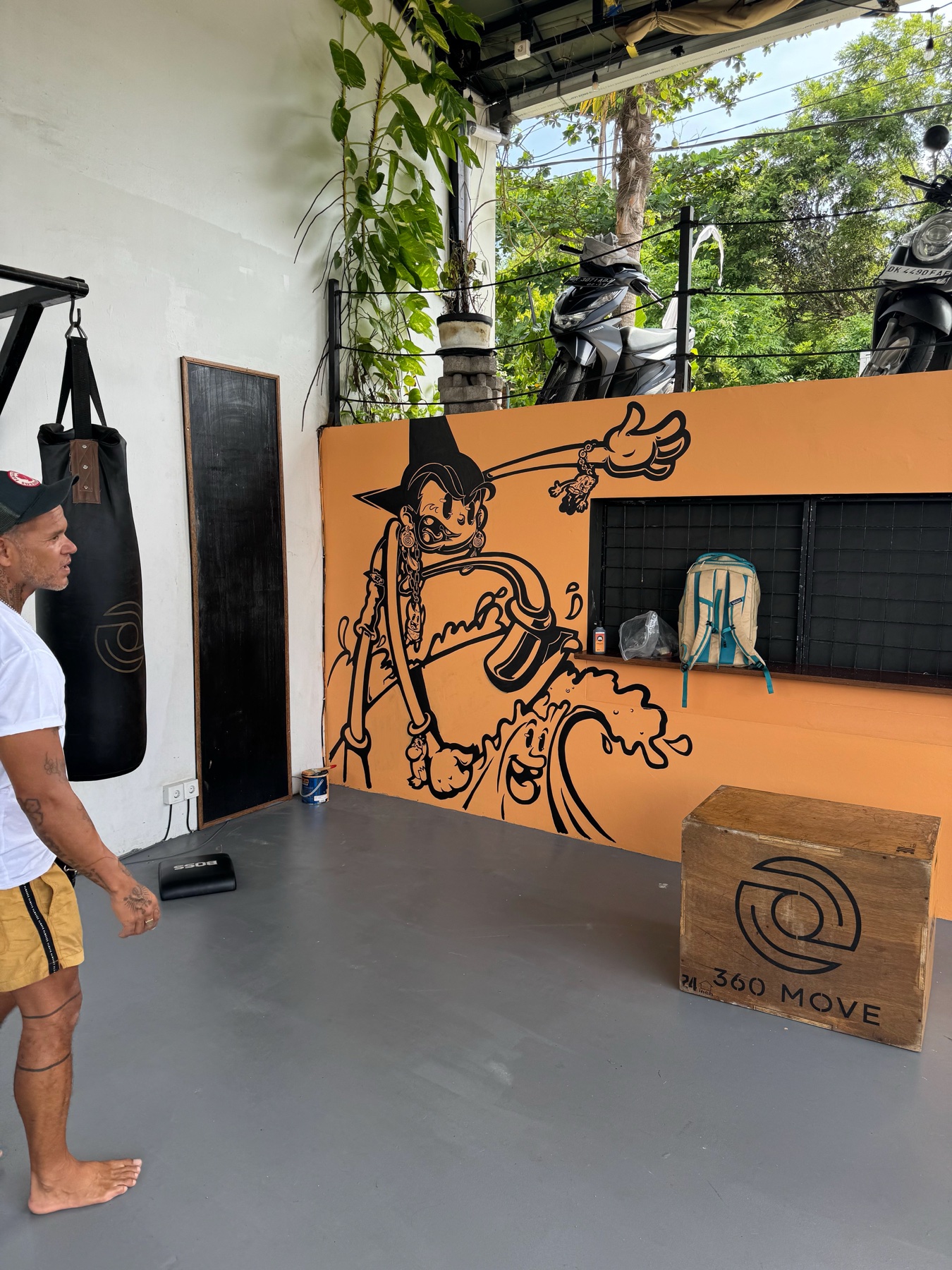 Orange gym wall mural painted by Jimi Grins